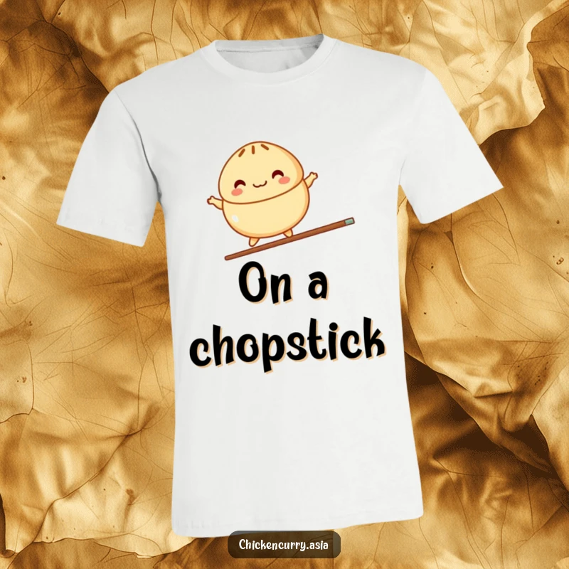 Funny t-shirt depicting a colorful, stylized steamed bun character joyfully balancing on a single chopstick with impressive skill.